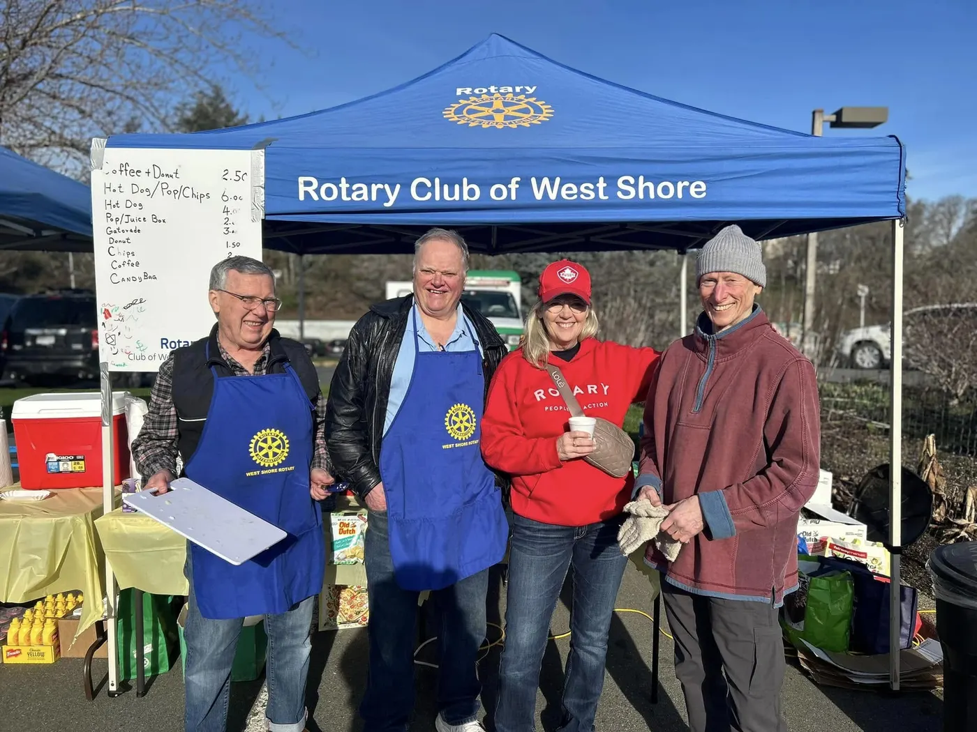 Four smiling members of the Rotary Club of West Shore at their tent